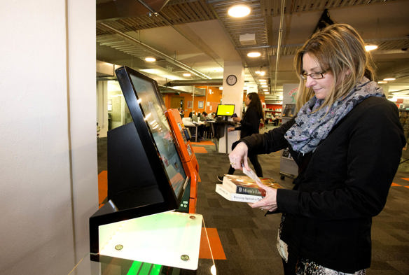 AJP201-NPlib31_woman at self check machine_resized.jpg